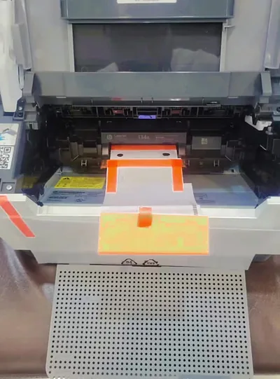 A new HP LaserJet Pro, still with its orange packing tape, at Printer Hut