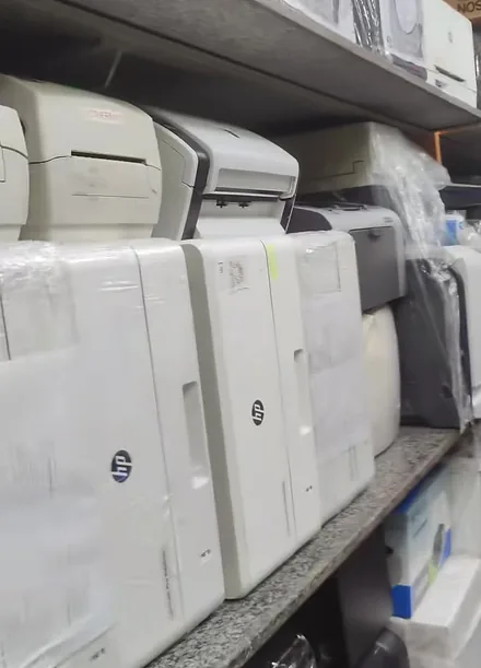 Unboxed laser printers lined up on the shelves at Printer Hut